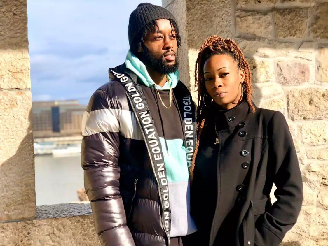 Two traders standing in front of a wall