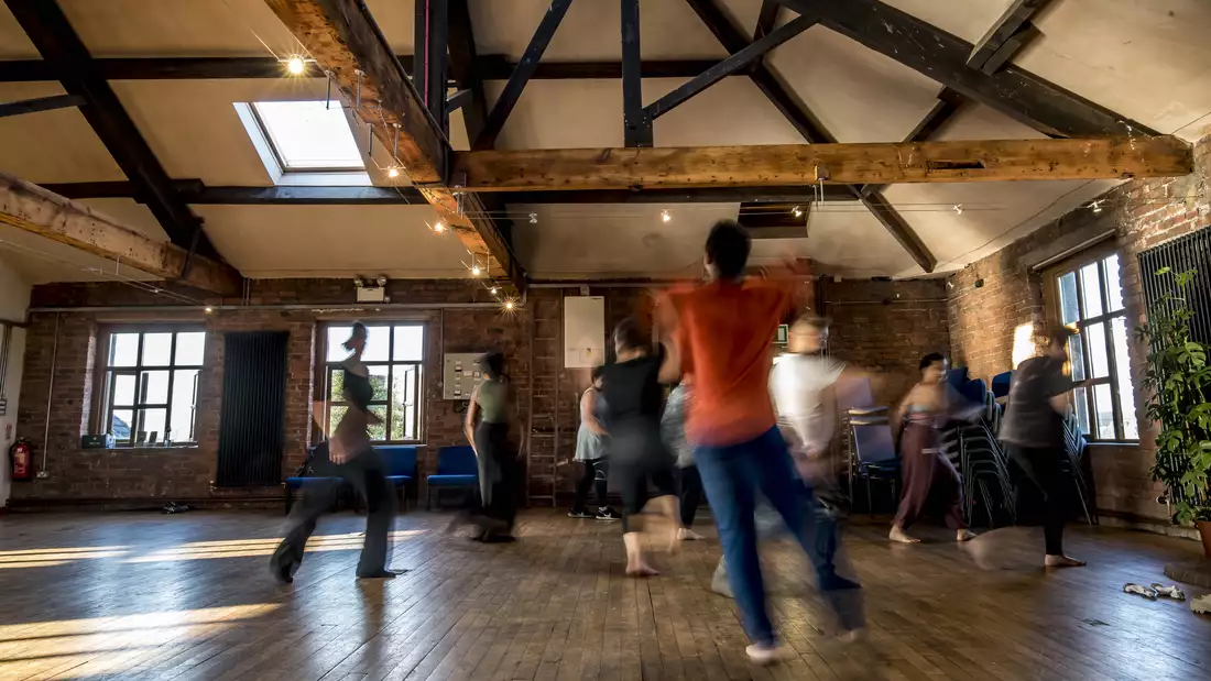 Photo of blurry people moving in a studio