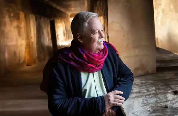 Armistead Maupin wearing a pink scarf