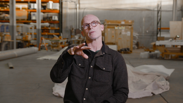 Artist Matthew Barney sitting and introducing his film