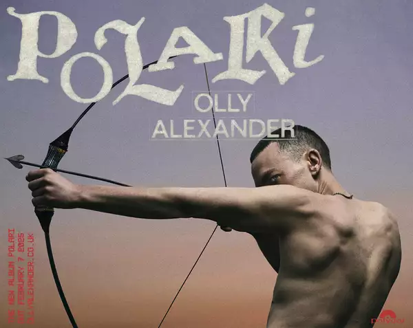 A promotional poster for an album titled "POLARI" by Olly Alexander. The design features Olly Alexander from the back, shirtless, holding a drawn bow with an arrow aimed forward, signifying focus and intensity. The background is a gradient sky transitioning from dark purple to a soft, warm sunset hue. The album's title "POLARI" is displayed in bold, textured lettering at the top, while "OLLY ALEXANDER" is written below in smaller, uppercase letters. On the left side, in red text, it mentions the album's release date as February 9, 2025. The Polydor Records logo is visible in the bottom-right corner.