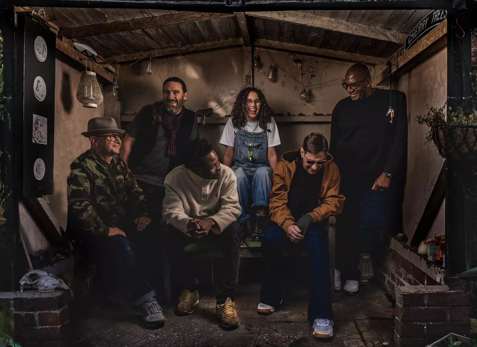 The band A Certain Ratio sitting in a garden shed