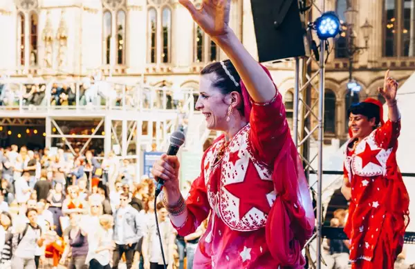 Woman on an outdoor stage holding a microphone