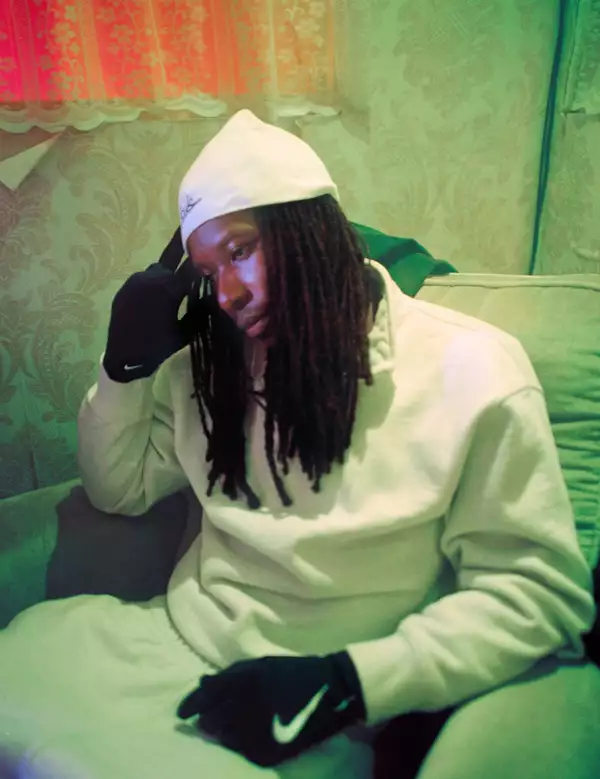 Photo of RenzNiro sat on a sofa wearing all-white